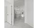Hallway view of the open concept floor plan showcasing the kitchen and living area at 3803 E Curtis St, Tampa, FL 33610