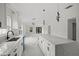 Kitchen showcasing quartz counters, shaker cabinets, pendant lights, and stainless steel appliances at 3803 E Curtis St, Tampa, FL 33610