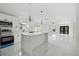 Modern kitchen with an island, stainless steel appliances, and stylish pendant lighting at 3803 E Curtis St, Tampa, FL 33610