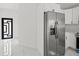 Stainless steel refrigerator in a kitchen featuring a modern door and white marble floors at 3803 E Curtis St, Tampa, FL 33610
