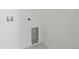 A utility space for laundry hookups on the wall with white trim and marble flooring at 3803 E Curtis St, Tampa, FL 33610