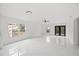 Bright living room featuring white walls, modern ceiling fan, and glossy white marble floors at 3803 E Curtis St, Tampa, FL 33610