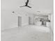Open-concept living room with white walls, a modern ceiling fan, and white marble floors at 3803 E Curtis St, Tampa, FL 33610