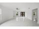 Bright living room features white walls, a ceiling fan, and sleek white marble floors at 3803 E Curtis St, Tampa, FL 33610