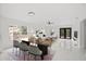 Open-concept living room with elegant dining area, featuring modern decor and stylish furnishings at 3803 E Curtis St, Tampa, FL 33610
