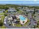Beautiful aerial view of a community pool surrounded by lush landscaping, palm trees, and views of the bay at 381 S Mcmullen Booth Rd # 72, Clearwater, FL 33759