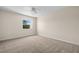 Bright bedroom featuring neutral carpet, a ceiling fan, and a window providing natural light and neighborhood views at 381 S Mcmullen Booth Rd # 72, Clearwater, FL 33759