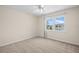Comfortable bedroom featuring neutral carpet and a large window providing natural light and neighborhood views at 381 S Mcmullen Booth Rd # 72, Clearwater, FL 33759