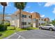 Exterior view of condo complex showcasing maintained grounds and unique architectural details at 381 S Mcmullen Booth Rd # 72, Clearwater, FL 33759