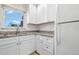 Bright kitchen with white cabinets, granite countertops, and modern appliances at 381 S Mcmullen Booth Rd # 72, Clearwater, FL 33759