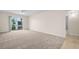 Spacious living room with neutral carpet, lots of natural light and a sliding glass door to the balcony at 381 S Mcmullen Booth Rd # 72, Clearwater, FL 33759
