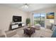 Bright living room with sliding door to balcony and comfortable seating arrangement at 381 S Mcmullen Booth Rd # 72, Clearwater, FL 33759