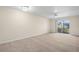 Spacious living room with neutral carpet, lots of natural light and a sliding glass door to the balcony at 381 S Mcmullen Booth Rd # 72, Clearwater, FL 33759