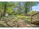 Spacious, tree-lined backyard with a fenced perimeter and room for outdoor activities at 3906 N Ola Ave, Tampa, FL 33603