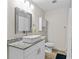 Modern bathroom with granite countertop, white vanity, and a walk-in shower at 3906 N Ola Ave, Tampa, FL 33603