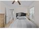 Bedroom with a queen bed, ceiling fan, side table, and ample natural light, a peaceful and inviting space at 3906 N Ola Ave, Tampa, FL 33603