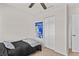 Simple bedroom with a single bed, ceiling fan, closet, and a bright window for a clean and uncluttered feel at 3906 N Ola Ave, Tampa, FL 33603