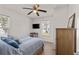 Comfortable bedroom with a ceiling fan, mounted TV, ample natural light, and hardwood floors, a relaxing retreat at 3906 N Ola Ave, Tampa, FL 33603