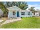 Charming light blue bungalow featuring a cozy front porch, neat landscaping, and well-maintained lawn at 3906 N Ola Ave, Tampa, FL 33603