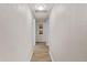Clean hallway featuring textured walls, light wood floors, and framed artwork, creating a simple, elegant transition at 3906 N Ola Ave, Tampa, FL 33603