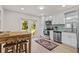 Bright, renovated kitchen with stainless steel appliances, white cabinets, and access to the backyard at 3906 N Ola Ave, Tampa, FL 33603