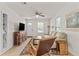 Inviting living room with a comfortable sofa, vintage cabinet, and a sunlit window at 3906 N Ola Ave, Tampa, FL 33603