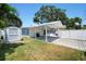 Expansive backyard featuring a covered parking area, shed for storage, patio, and lush green lawn at 430 44Th Ne Ave, St Petersburg, FL 33703
