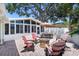 Inviting backyard with brick patio, outdoor seating, fire pit, and sunroom perfect for entertaining at 430 44Th Ne Ave, St Petersburg, FL 33703
