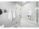 Modern bathroom featuring a glass enclosed shower, white subway tile, and decorative blue-patterned flooring at 430 44Th Ne Ave, St Petersburg, FL 33703