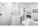 White bathroom with a glass shower, a sliding barn door and patterned floor tiles at 430 44Th Ne Ave, St Petersburg, FL 33703