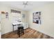 Well-lit bedroom with wood floors, shelves, closet, and sewing station at 430 44Th Ne Ave, St Petersburg, FL 33703