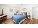 Bedroom featuring a queen bed, wood floors, a window and a ceiling fan at 430 44Th Ne Ave, St Petersburg, FL 33703