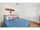 Bright bedroom featuring a queen bed, wood floors, a window, a ceiling fan, and closet at 430 44Th Ne Ave, St Petersburg, FL 33703