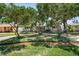 Charming single-story home showcasing mature trees, lush landscaping, and a brick-paved driveway at 430 44Th Ne Ave, St Petersburg, FL 33703