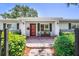 Inviting front porch with a brick walkway, stylish bench, and well-maintained landscaping at 430 44Th Ne Ave, St Petersburg, FL 33703