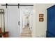 Bright hallway with a barn door and light wood-look floors that lead to the rest of the house at 430 44Th Ne Ave, St Petersburg, FL 33703