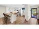 Bright kitchen featuring a breakfast bar, stainless steel appliances, and wood-look flooring at 430 44Th Ne Ave, St Petersburg, FL 33703
