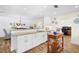 Open kitchen featuring a large island with bar seating, white cabinetry, and modern appliances at 430 44Th Ne Ave, St Petersburg, FL 33703