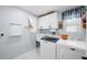 Well-equipped laundry room with modern washer and dryer, storage cabinets, and a utility sink for added convenience at 430 44Th Ne Ave, St Petersburg, FL 33703
