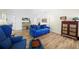 Beautiful living area with bright blue sofas and wood flooring at 430 44Th Ne Ave, St Petersburg, FL 33703