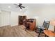 Bright office featuring a cozy chair, wooden desk and bookshelf with new flooring at 430 44Th Ne Ave, St Petersburg, FL 33703