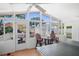 Bright sunroom with multiple windows, ceiling fan, and ping pong table; perfect for relaxation and entertainment at 430 44Th Ne Ave, St Petersburg, FL 33703