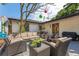 This backyard offers multiple patio seating options and a surfboard for added flair at 433 San Salvador Dr, Dunedin, FL 34698