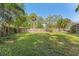 Large backyard featuring lush lawn and wooden fence, ideal for recreational activities and privacy at 433 San Salvador Dr, Dunedin, FL 34698
