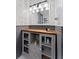 Bathroom features a dark wood countertop, grey cabinetry, and grey and white wallpaper at 433 San Salvador Dr, Dunedin, FL 34698