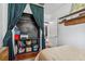 This bedroom features a closet with emerald green curtains, wood shelving, and exposed wood flooring at 433 San Salvador Dr, Dunedin, FL 34698
