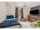 This bedroom includes a twin bed, a desk area, and a window with dark grey curtains at 433 San Salvador Dr, Dunedin, FL 34698