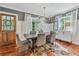 Elegant dining room with stylish gray chairs, wooden floors, and natural light shining through the windows at 433 San Salvador Dr, Dunedin, FL 34698