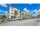 Beautiful commercial building with parking and palm trees against a blue sky with puffy white clouds at 433 San Salvador Dr, Dunedin, FL 34698