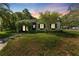 Charming single-story home with a well-manicured lawn and an inviting, plant-covered archway entrance at 433 San Salvador Dr, Dunedin, FL 34698